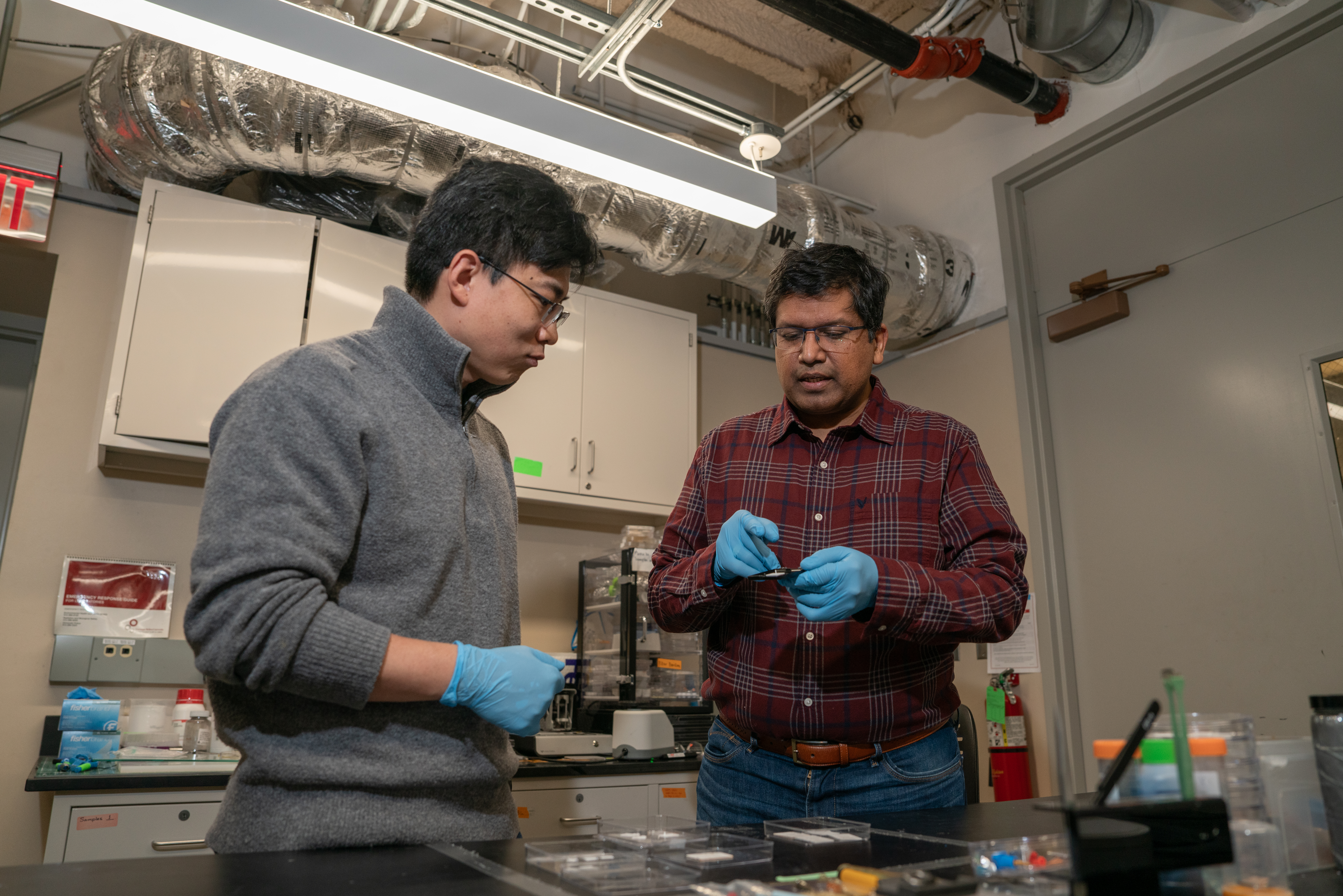 A faculty member listens to a graduate student