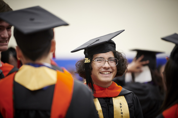Student smiling at graduation ceremony