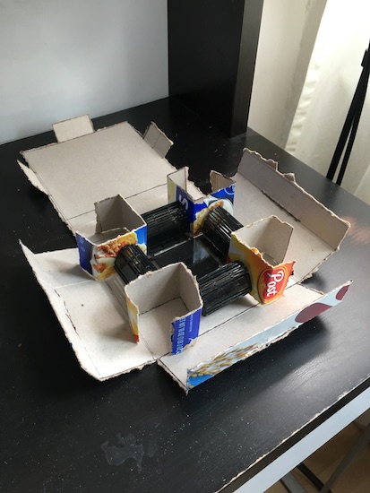 The inside of the cereal box project shows folded cardboard to secure the device inside.