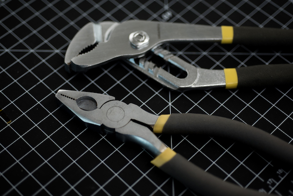 a photo of pliers on a graphed surface