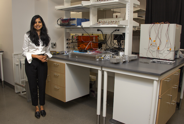 Professor Jayan standing at her lab table
