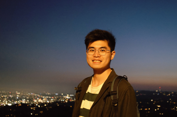 Liwei Wang in front of city lights