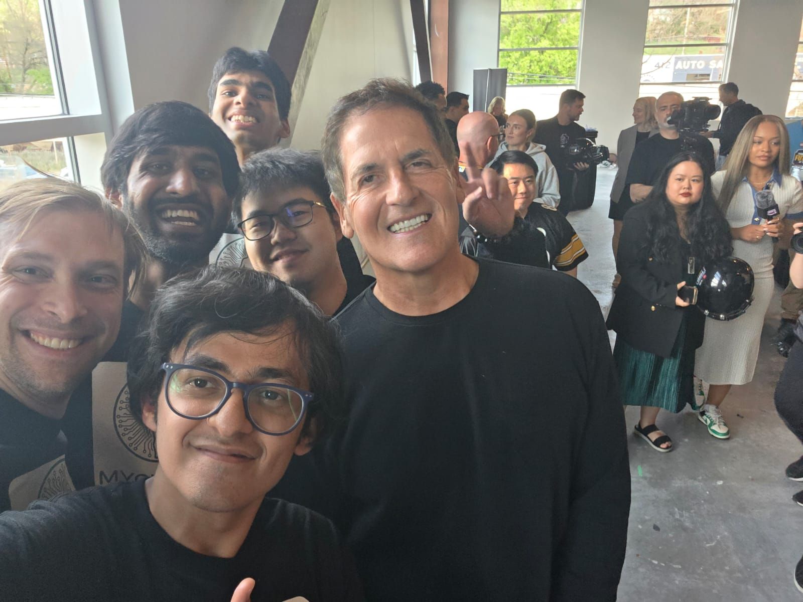 students standing with Mark Kuban