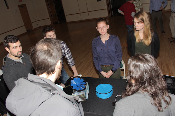 Mechanical engineering students demo a portable hydroelectric device.